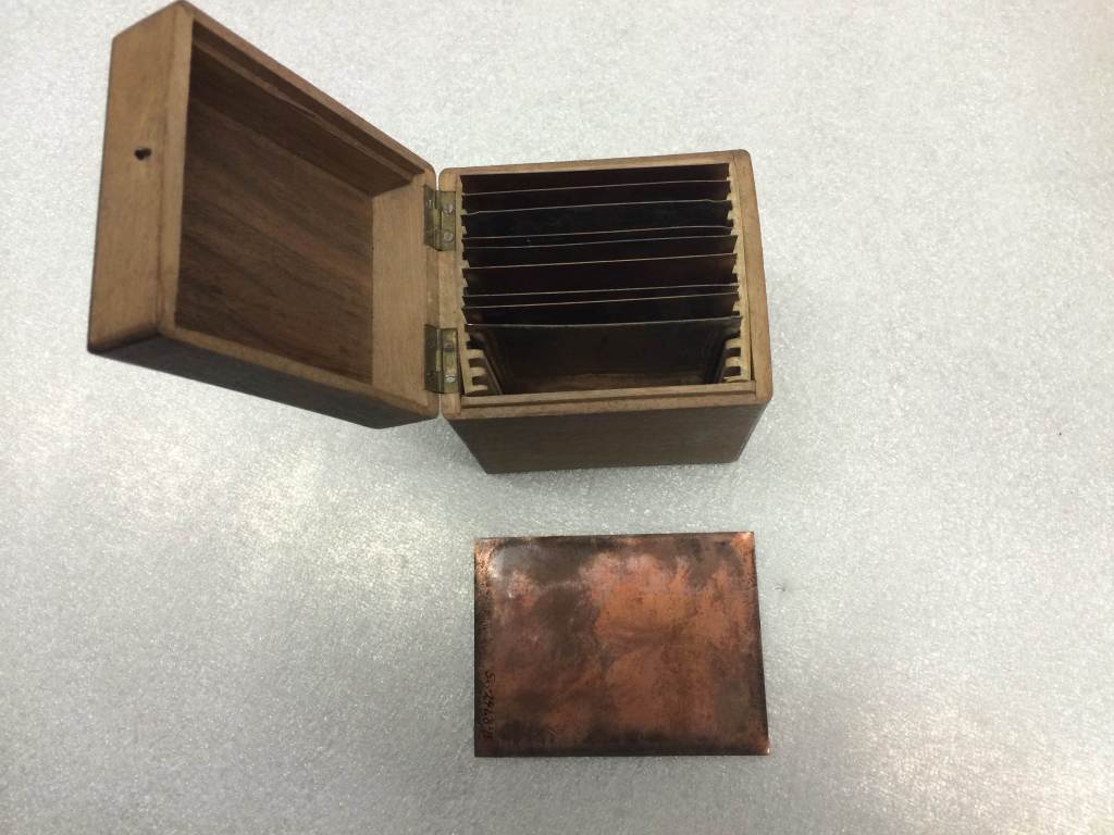 Blank copper plates, used in the process of making daguerreotypes, in a wooden storage container