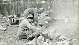 Agnes Vaille and a fellow member of CMC cook on a campfire.