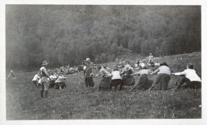 CMC members play a game of tug-of-war in a meadow.