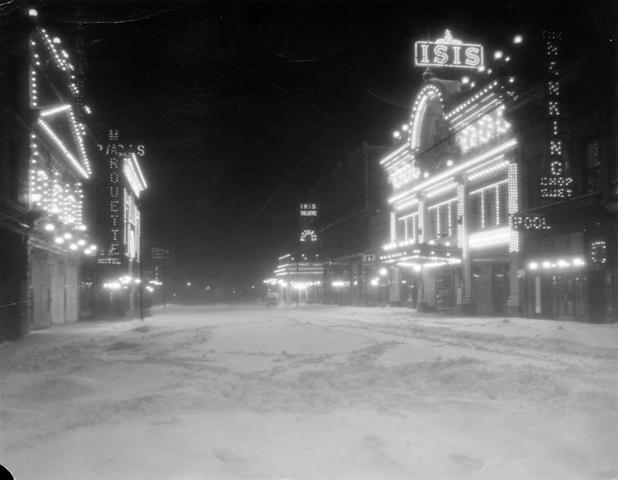 Night view of a snow-covered Curtis Street in Denver, Colorado, circa 1913-1919