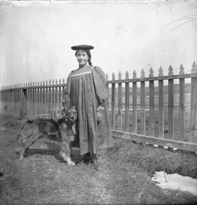 Eugenia R. Kennicott at age 12, posing in her yard with her dog Penny