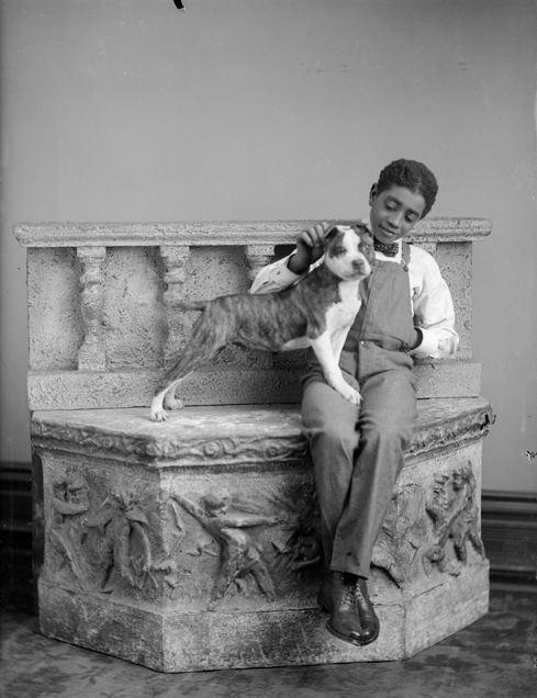 Studio portrait of young boy with dog, taken by Oliver Aultman, c. 1900.