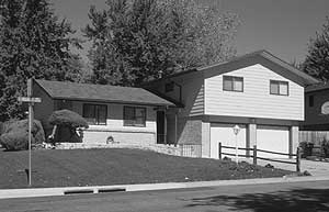 Black and white photo of a split-level home