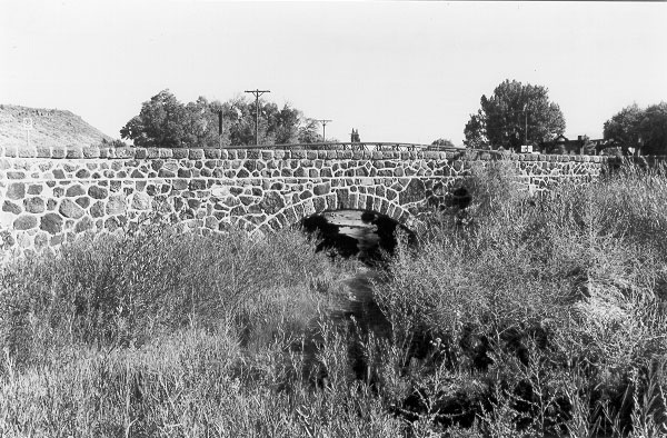 Black and white photo of the Rito Seco Creek Culvert showing local volcanic fieldstone facing.