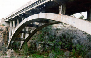 A view of the bridge from beneath with cross girders holding it up. 