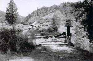 A black and white photo of the collapsed bridge.