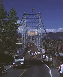 A view of the bridge from the center with jeep in front.