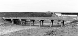 A photo of the bridge over the creek with multiple abutments below. 