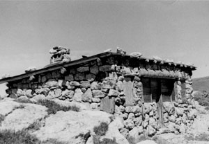 A black and white photo of the stone station surrounded by stones. 