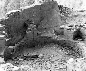 A photo of a ringed wall within a larger structure in black and white.
