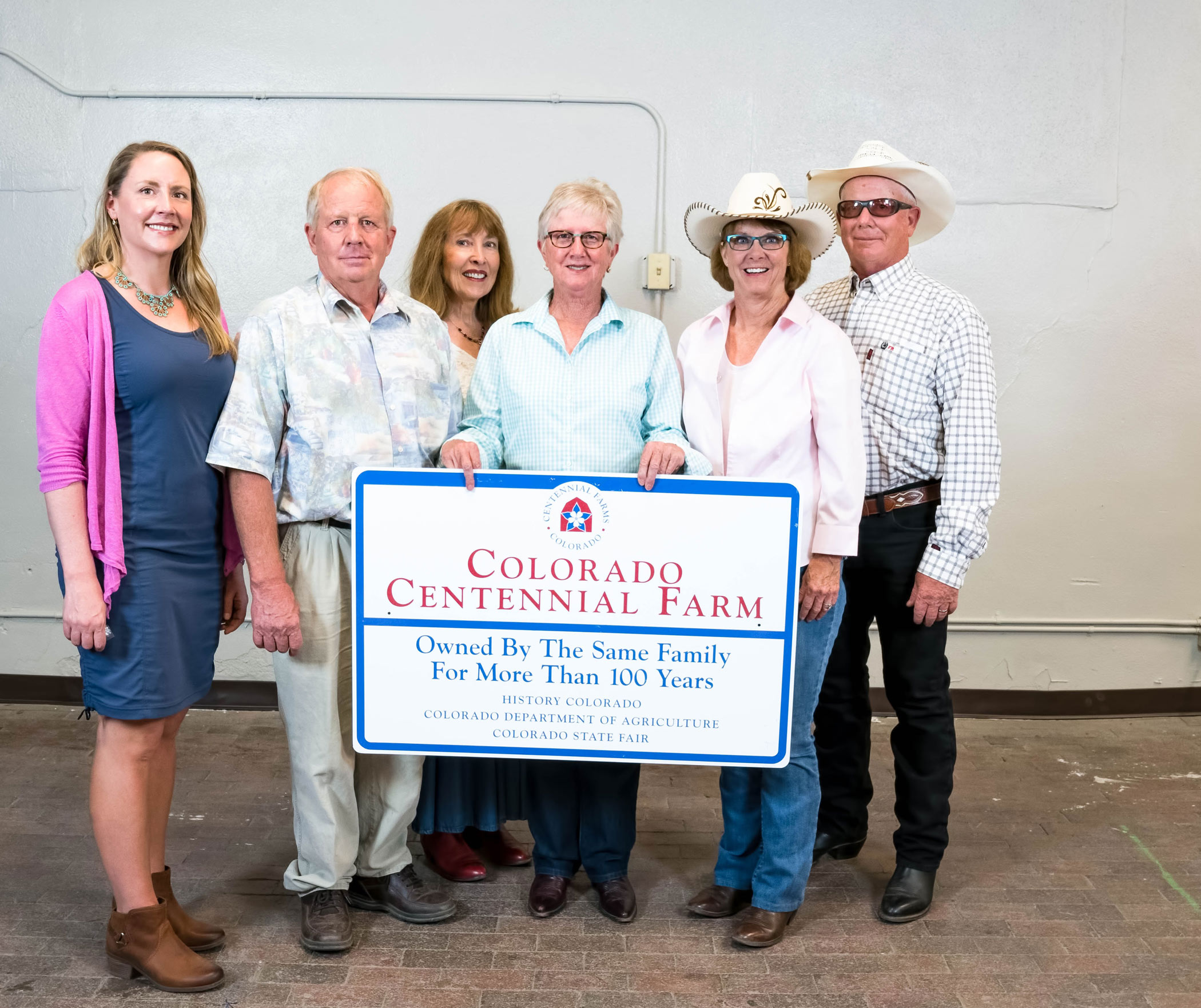 Members of the Zink family with their Centennial Ranch sign.