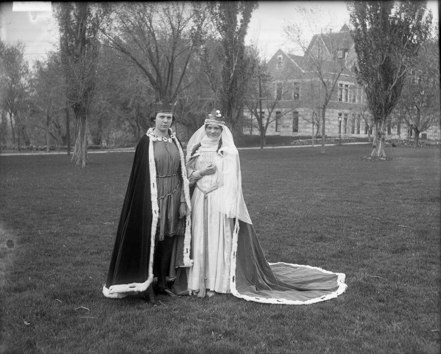 Two women dressed as a king and queen in a vintage Halloween photograph.