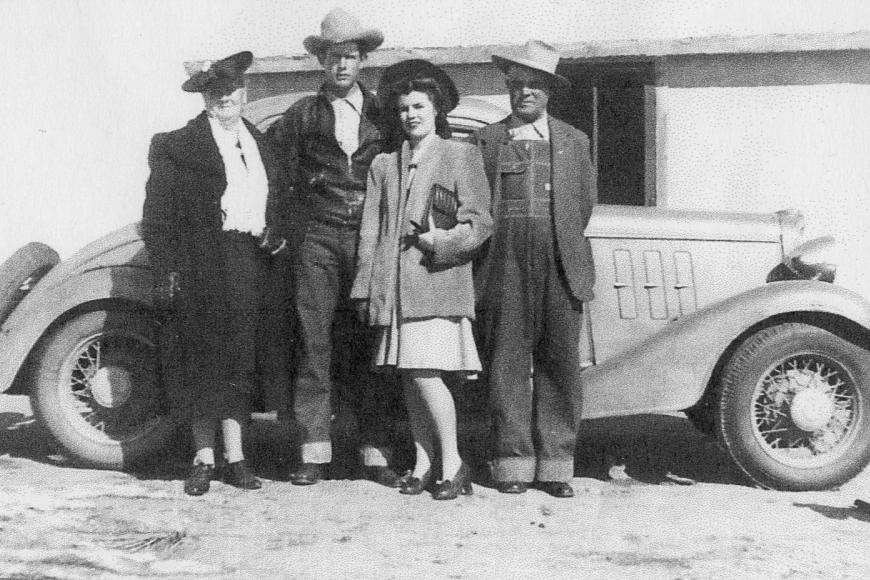 Members ofThe Bailey family standing in front of a car on the ranch, 1943.