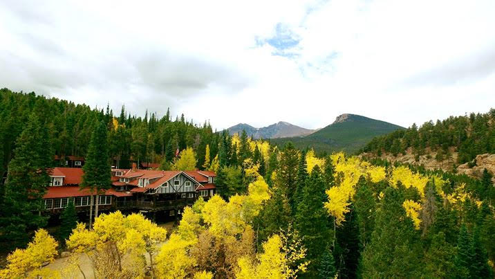 The Baldpate Inn near Estes Park nestled among golden aspen and green conifer.