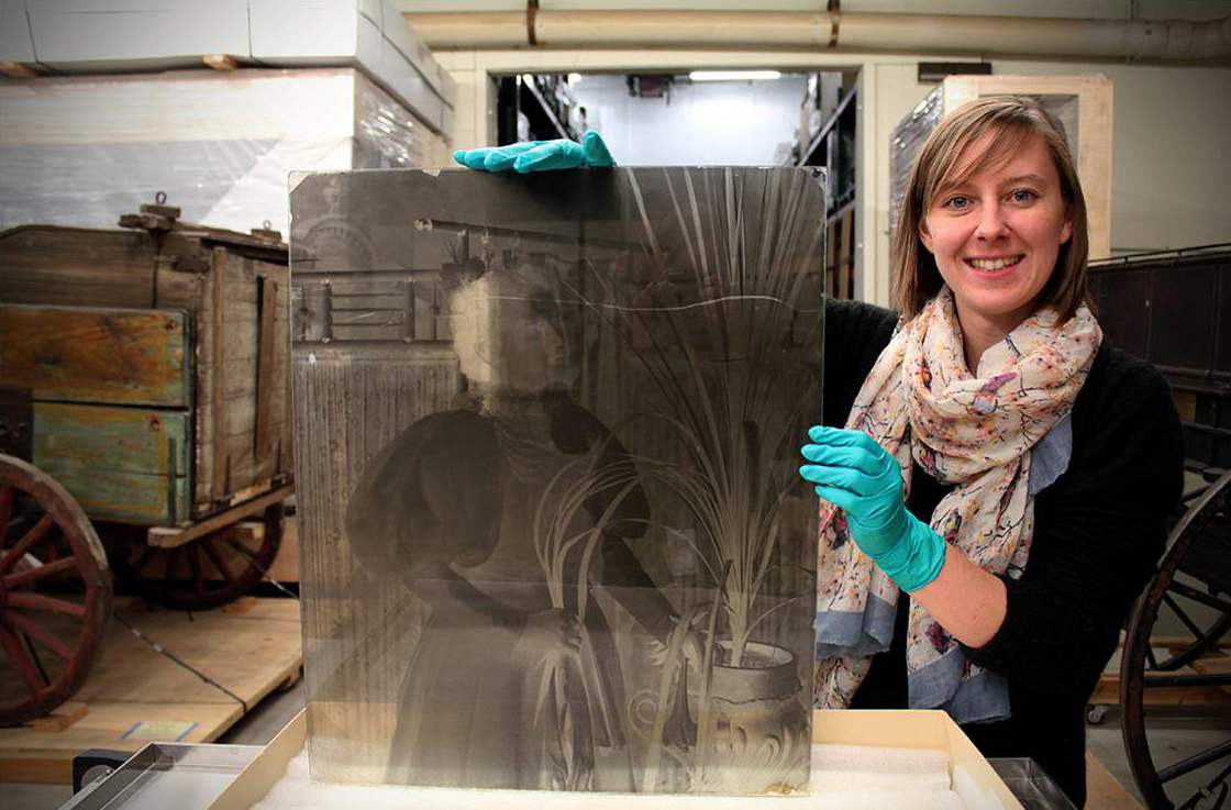 Intern Erica San Soucie with a mammoth glass negative from the Aultman Studio collection