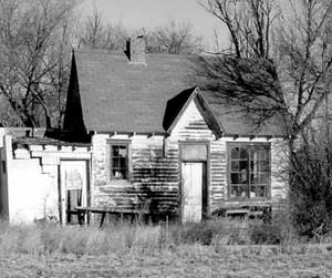 Photograph of abandoned cottage gas station.