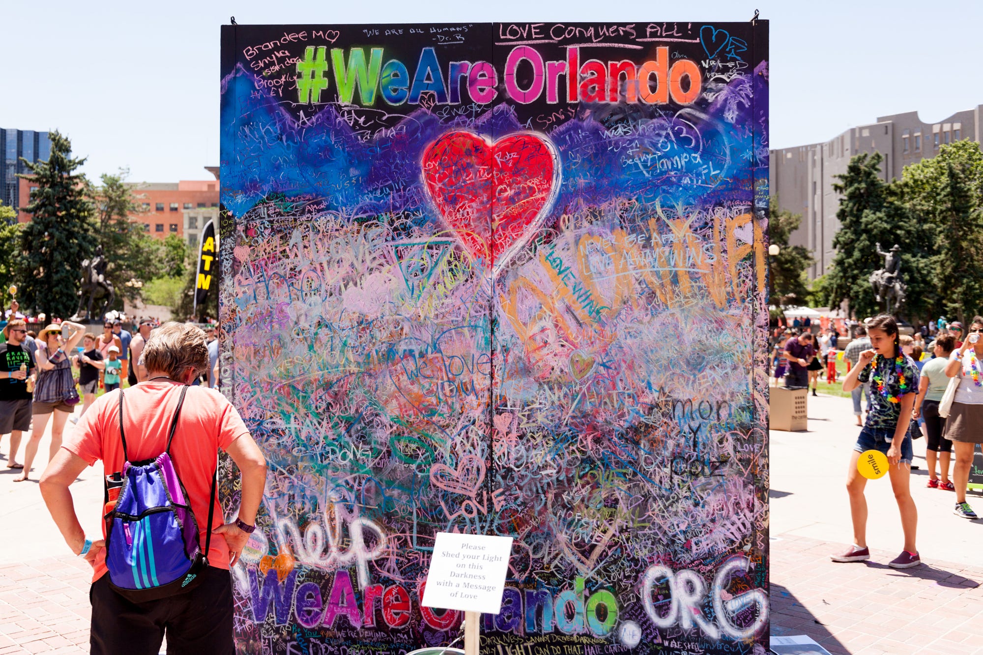 A woman reads the messages left in chalk honoring the victims of the 2016 Orlando nightclub attack.