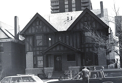 Black and white photo of a Tudor Revival style home.
