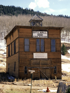 A view of the building with wood panels and sign that says 'City Hall' in the center.