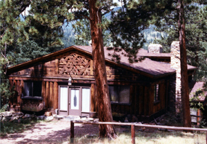 A photo of the house with trees surrounding it.