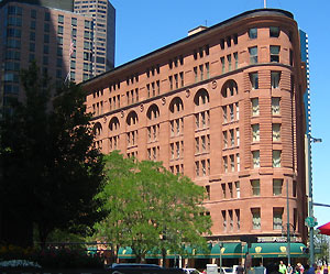 A view of the Brown Palace from a distance with two trees on the left. 