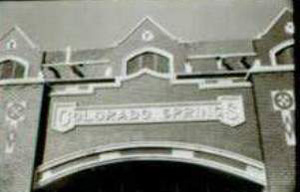 A black and white photo of the top of the entrance of the depot, with a large horizontal arch on bottom, and the word "Colorado Springs" written on the facade.