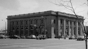 A black and white photo of the building from a corner across the street.