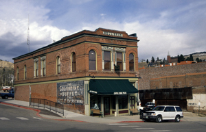 A view of one of the buildings in the district with arched windows and green awning in the front.