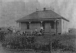 Historic photo of the frame house on the Poe Family Farm, in 1913 after it was moved to the site of the original sod house.