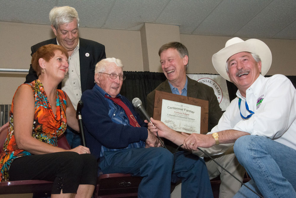 Lyman Edgars receives his Centennial Farm award from Governor John Hickenlooper.