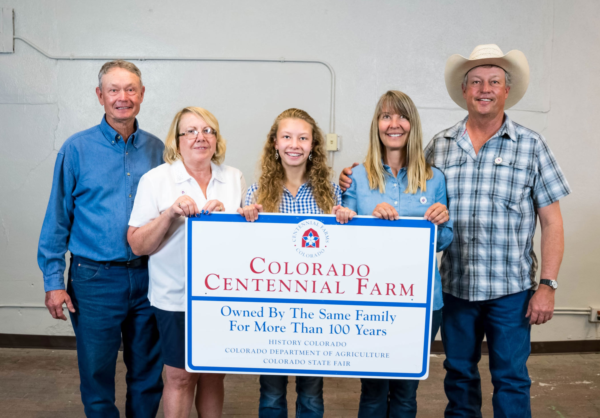 The Murray family poses with their metal Centennial Farms sign during the 2017 ceremony.