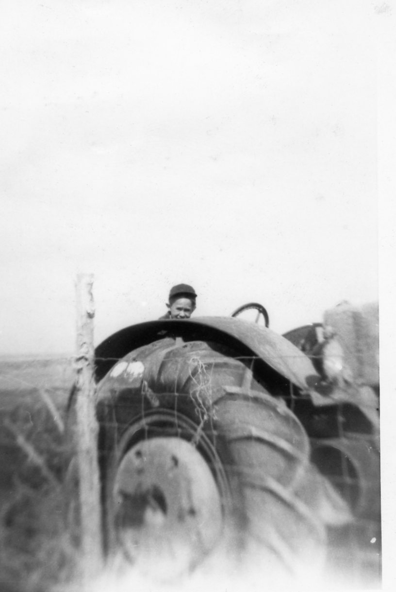 Historic photo of a boy on a tractor at the Weirich Ranch.