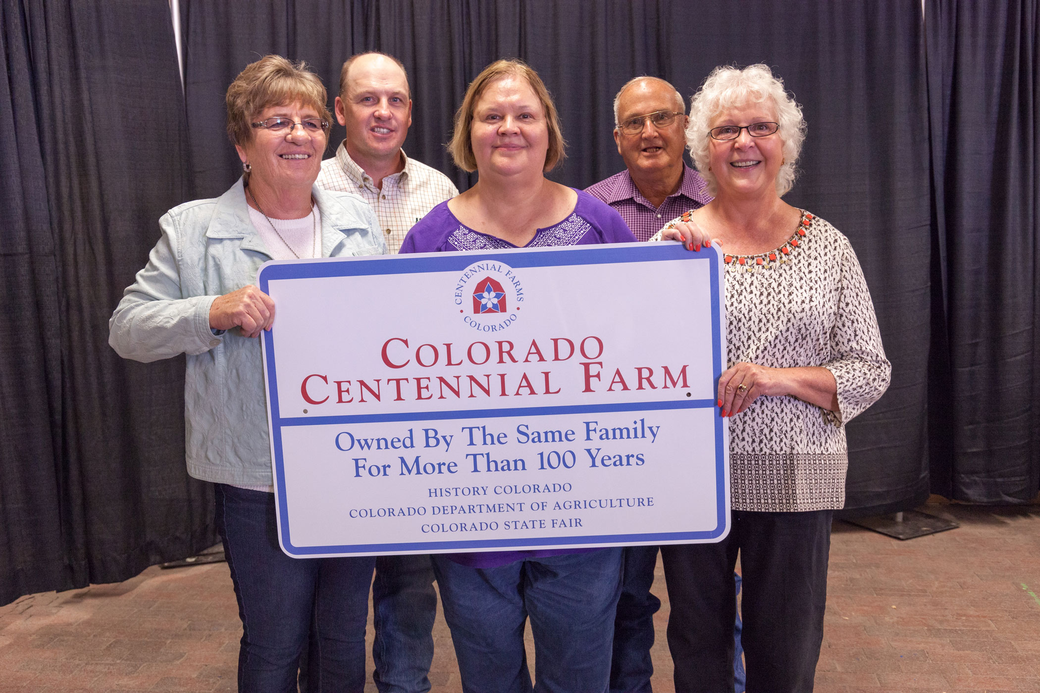 Cyrilla and Edith Meis Farm family with their Centennial Farm sign.