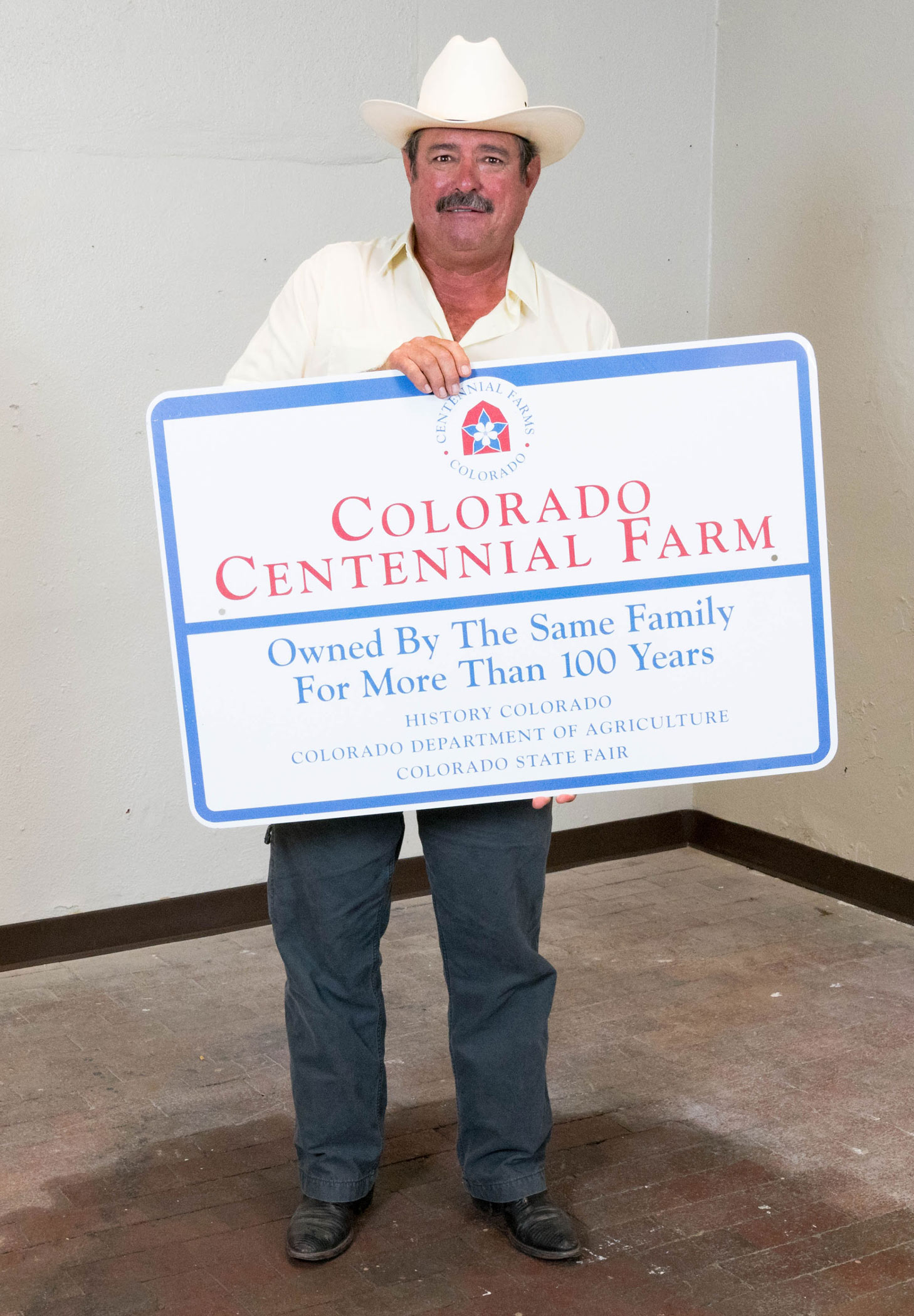Michael Hogue with his Centennial Farm sign