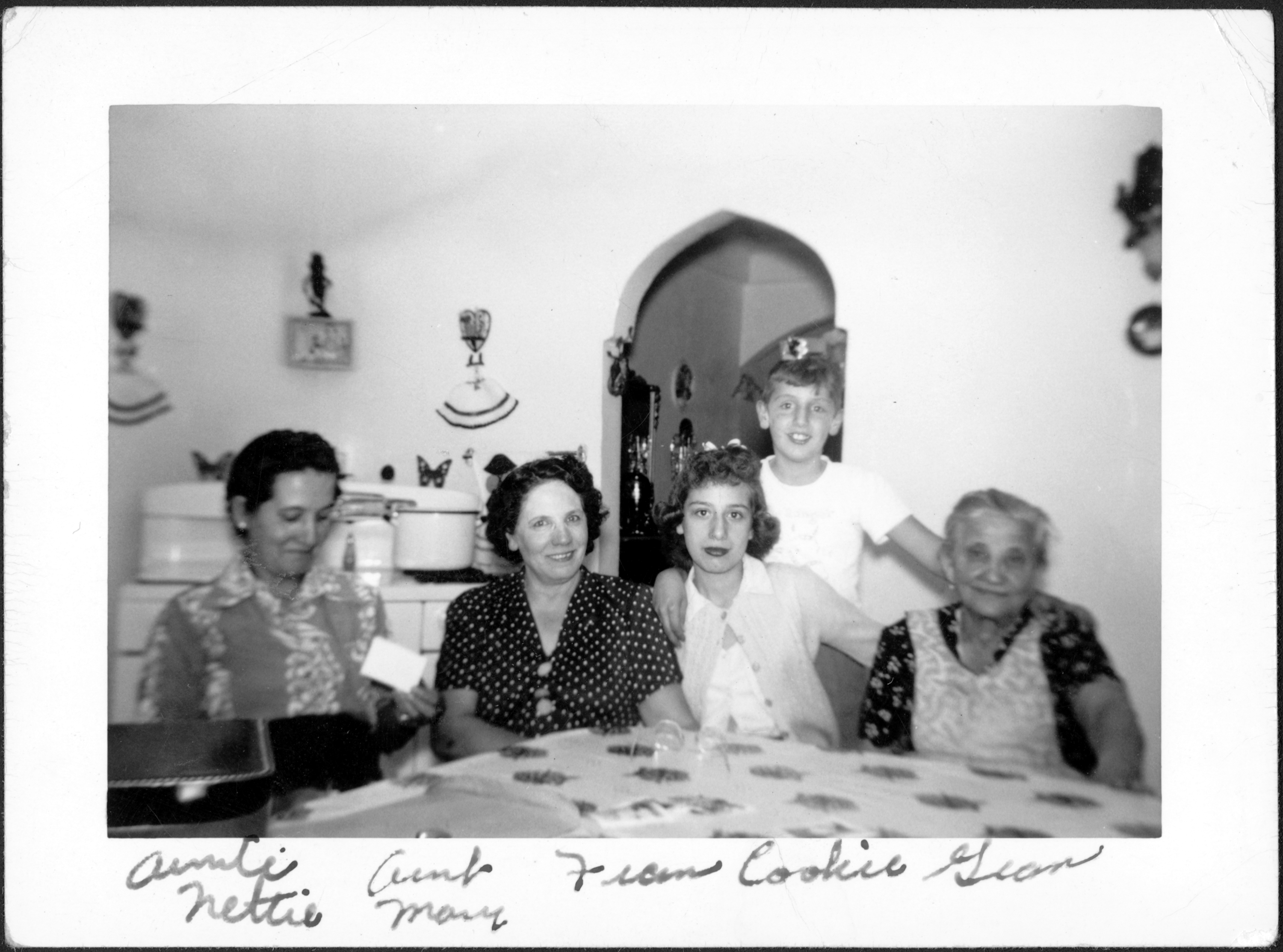 Photograph of Aunt Nettie, Aunt Mary, Frances, Cookie, and Gram Sitting Around Kitchen Table. 