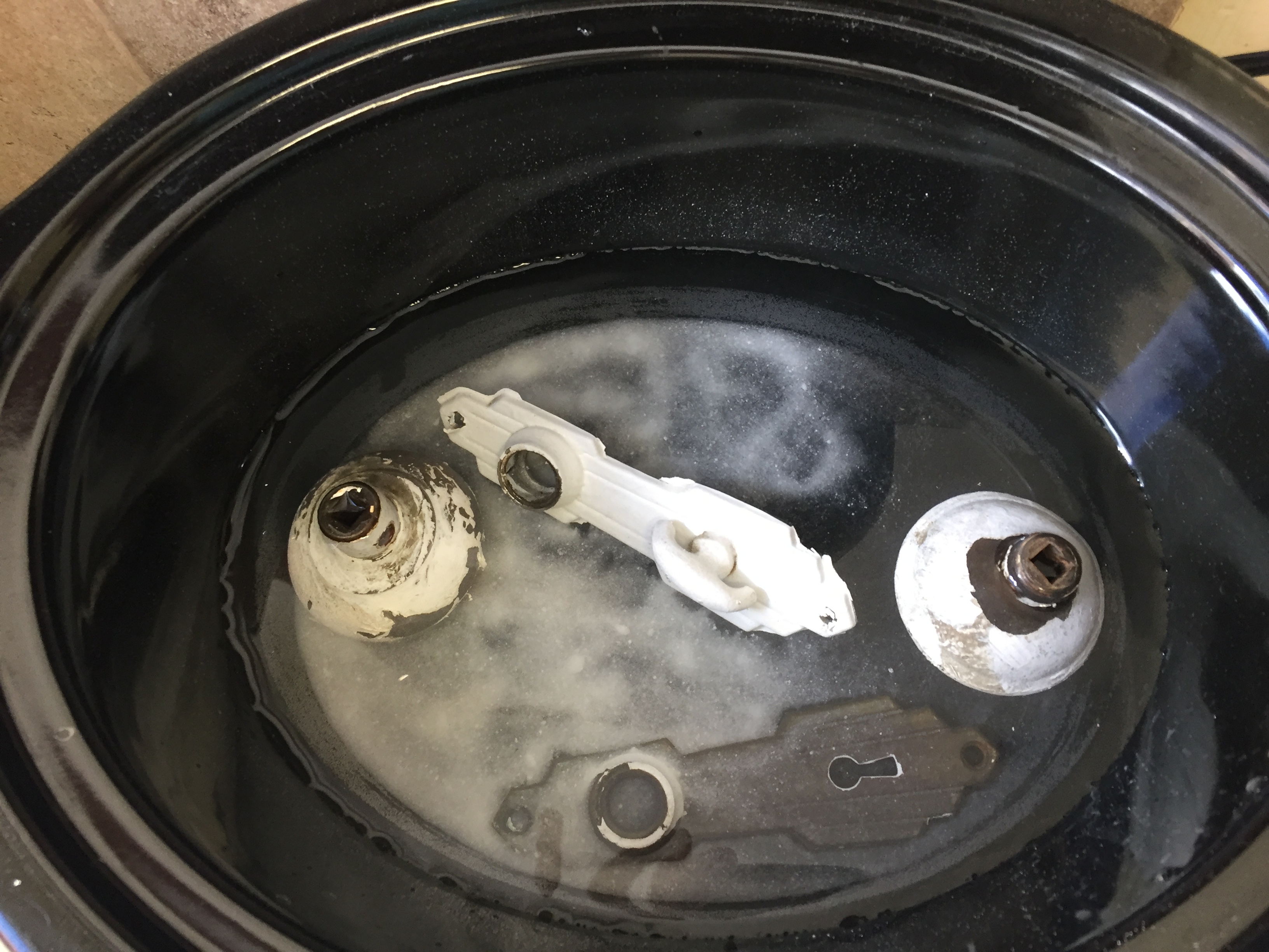 Door knobs in slow cooker with mild detergent