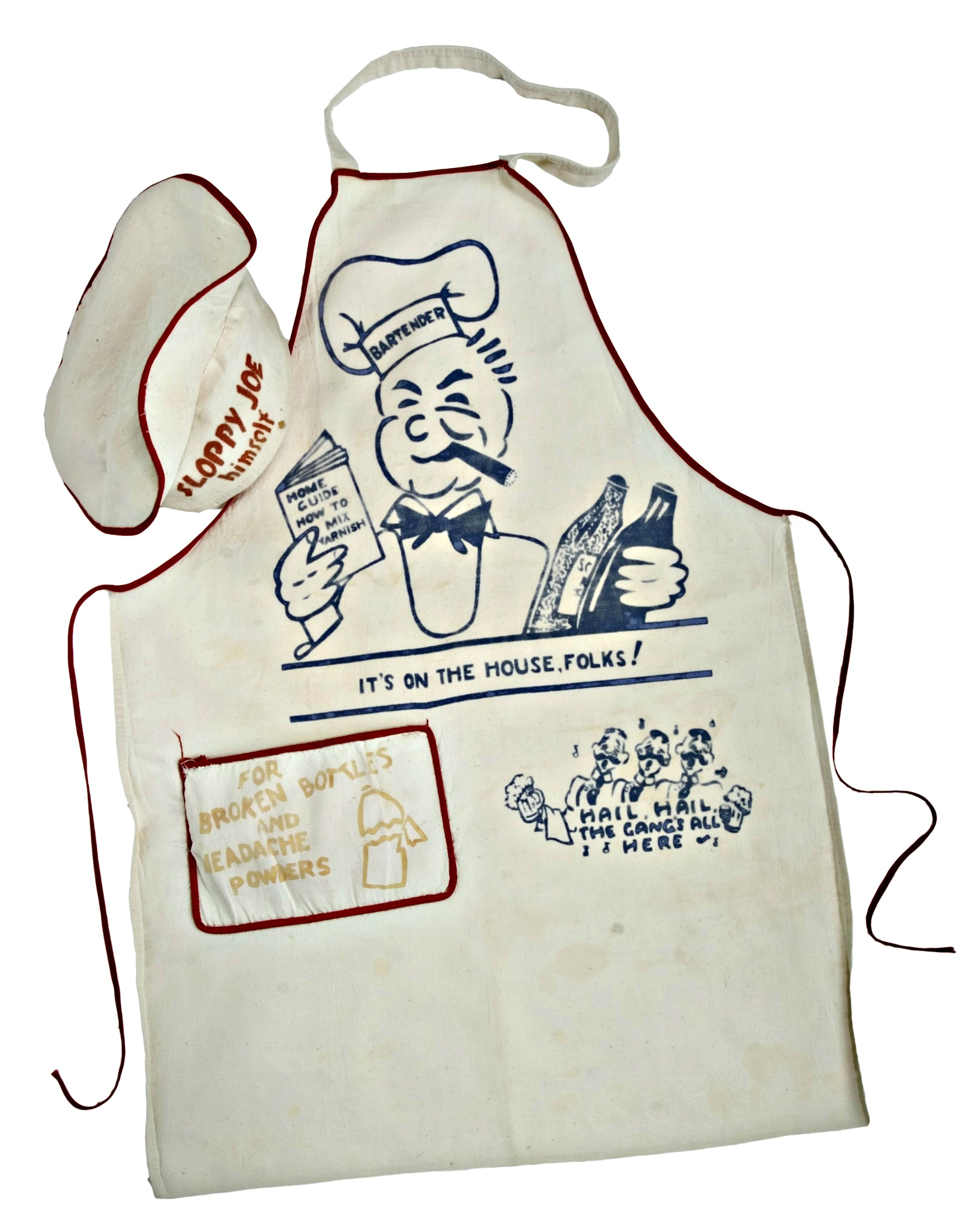 Photo of a white apron and matching chef-style hat. They are trimmed in red and there is a large cartoonish man on the front of the apron. This character wears a chef hat that says "bartender" and he is smoking a cigar. He holds 2 bottles in his left hand and a book in the right hand. The caption beneath reads, "It's on the house, folks!" The hat that is part of the ensemble says "Sloppy Joe himself" on the brow. 