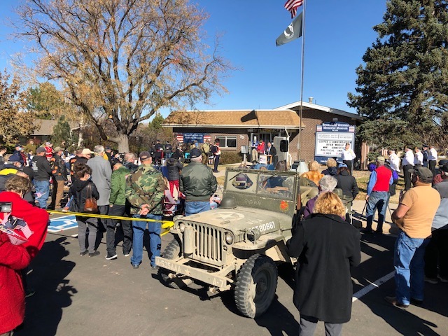 A shot of the crowd at the 2020 Veterans Memorial Day event at the Broomfield Veterans Memorial Museum, November 11, 2020.  Many of the attendees are shown wearing masks and distancing as the flag is raised. 
