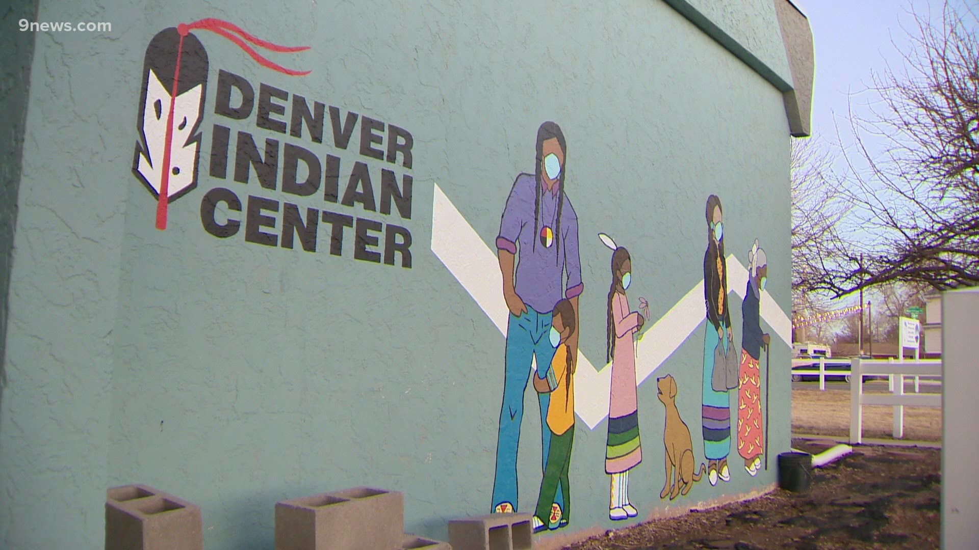 A mural on the Denver Indian Health Center with individuals wearing face coverings. 