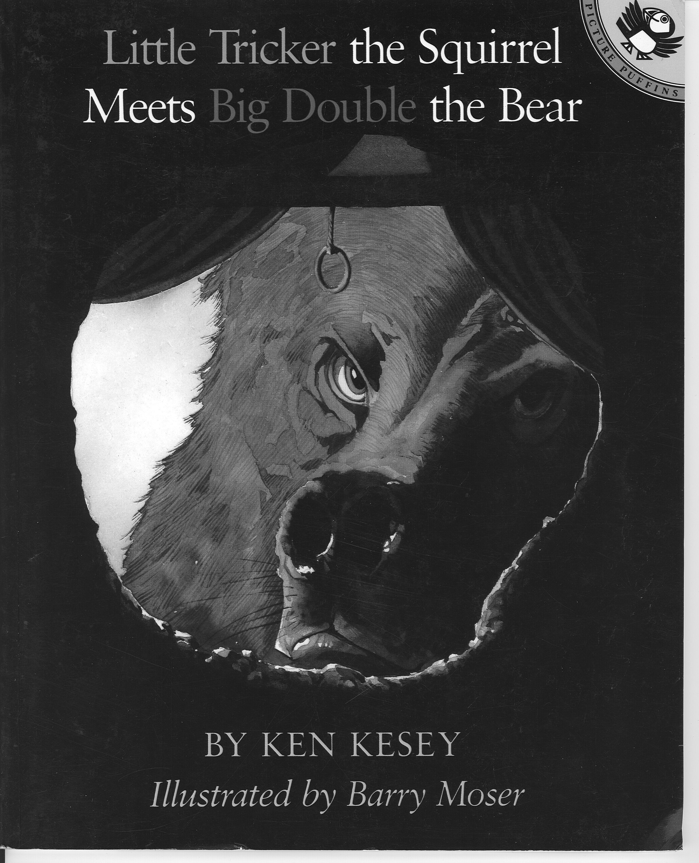Image of the cover of the children's book, Little Tricker the Squirrel Meets Big Double the Bear, by author Ken Kesey. Illustrated by Barry Moser. The cover of the book features the illustration of a frustrated bear, looking into the hole of a tree trunk, that is someone's home. The hole has curtains which are pulled back to each side, and the pull ring of a roller blind is hanging down.