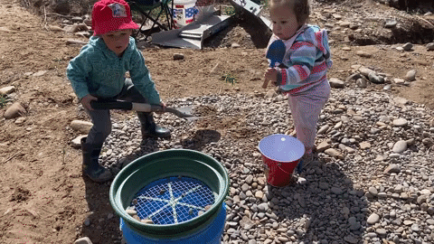 Kids using a classifier during gold panning activities.