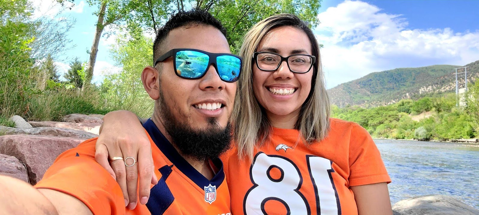 Kelvin Martinez and compañera pose in Broncos shirts. 