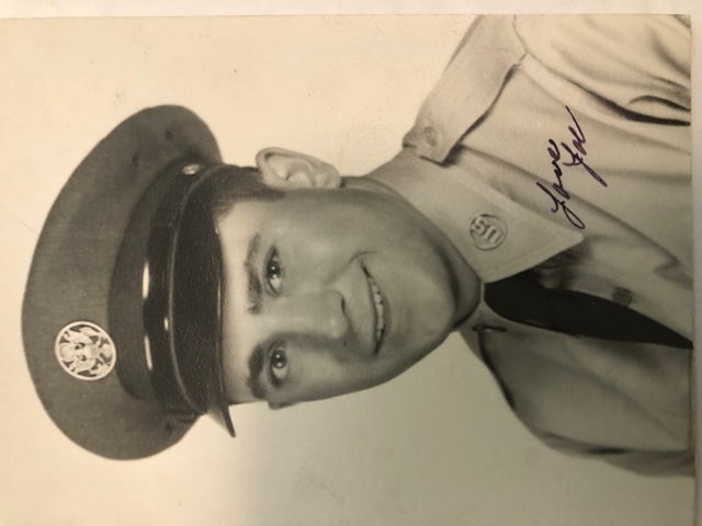 A young man wears a United States Air Force uniform. He is smiling.