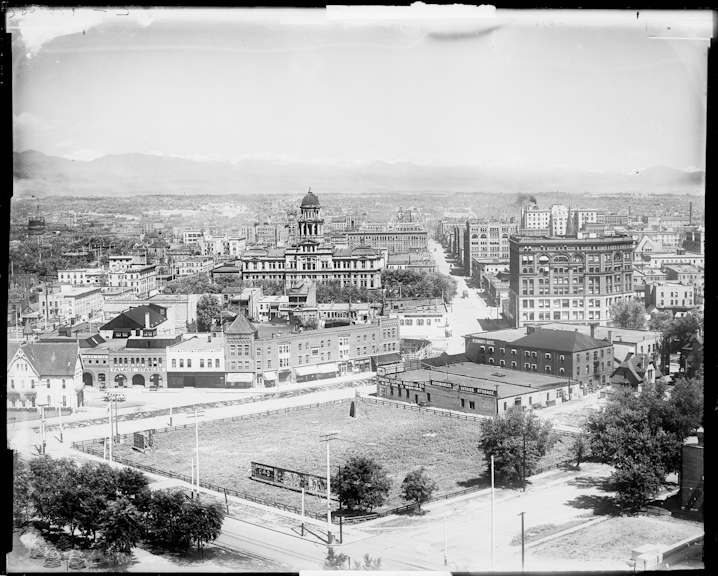 Panoramic view of Denver, Colorado from the Capitol Building. Shows the Arapahoe County Courthouse, a Greek Revival building with a dome topped by a tin statue of "Justicia." Shows the Kittredge Building on 16th Street, the Hotel Broadway at the intersection of 16th Street and Broadway, and the Denver Fire Department's Engine House no. 1on the corner of Colfax and Broadway. Signs read: "Palace Stables," "Drink Zang's Pilsner Beer, Broadway Bar," "Hotel Broadway," "Automobiles, Repairs, Storage."