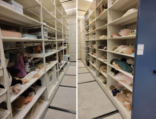 Photo of white floor-to-ceiling shelves of the collections area of the museum. The large room is painted white with white floors, and dolls and other boxes can be seen laying on the shelves in storage.