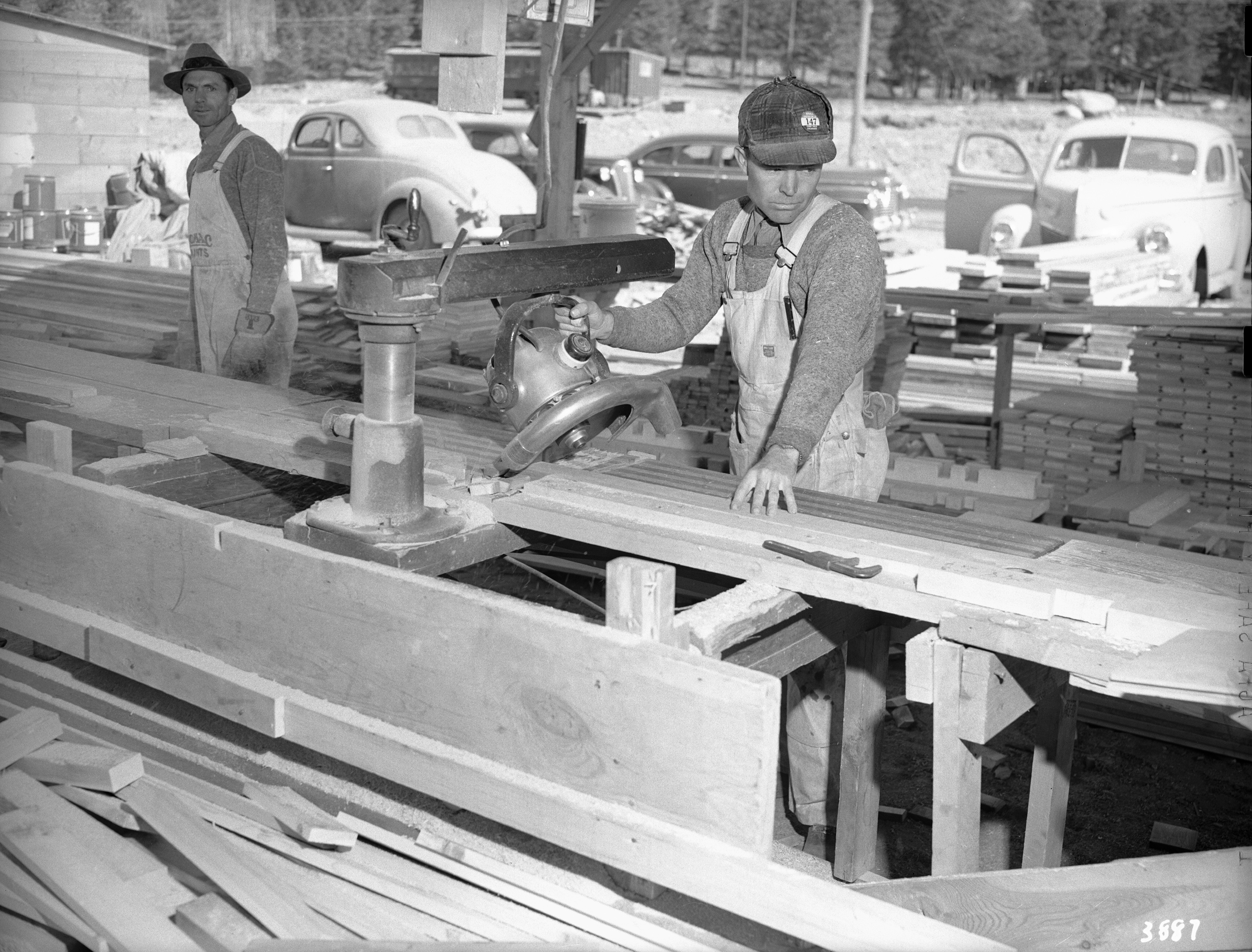 A carpenter cutting boards of wood.