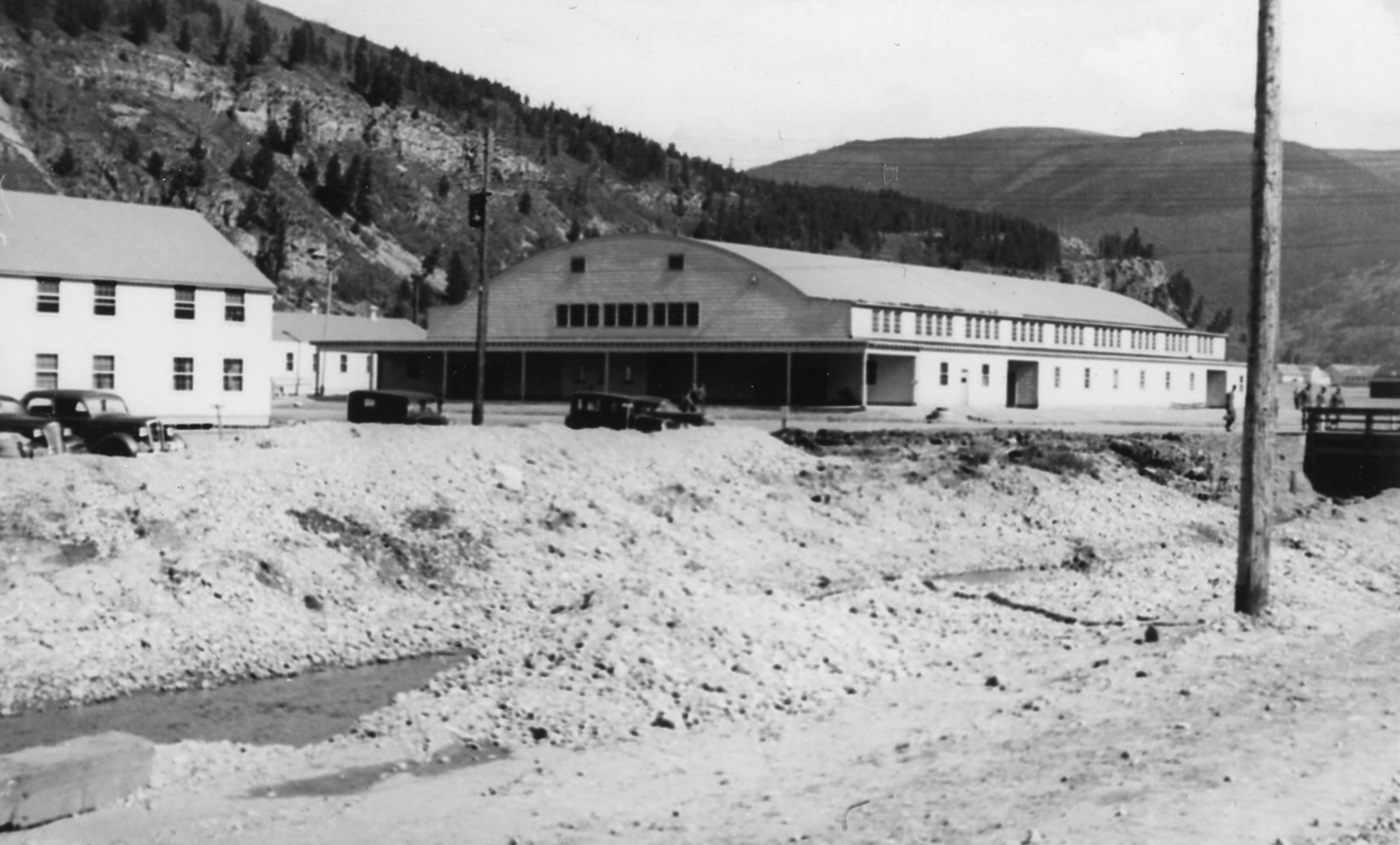 A larger building with an arced roof in the center of Camp Hale.