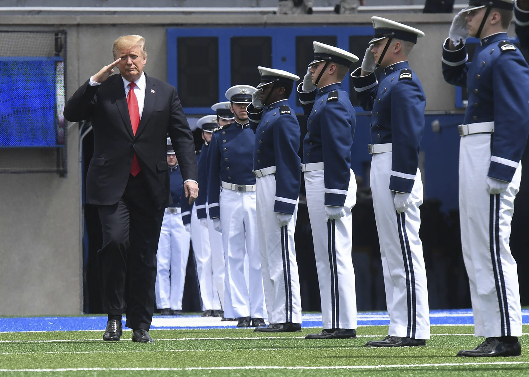 President Donald Trump walks along a line of Air Force Academy cadets.