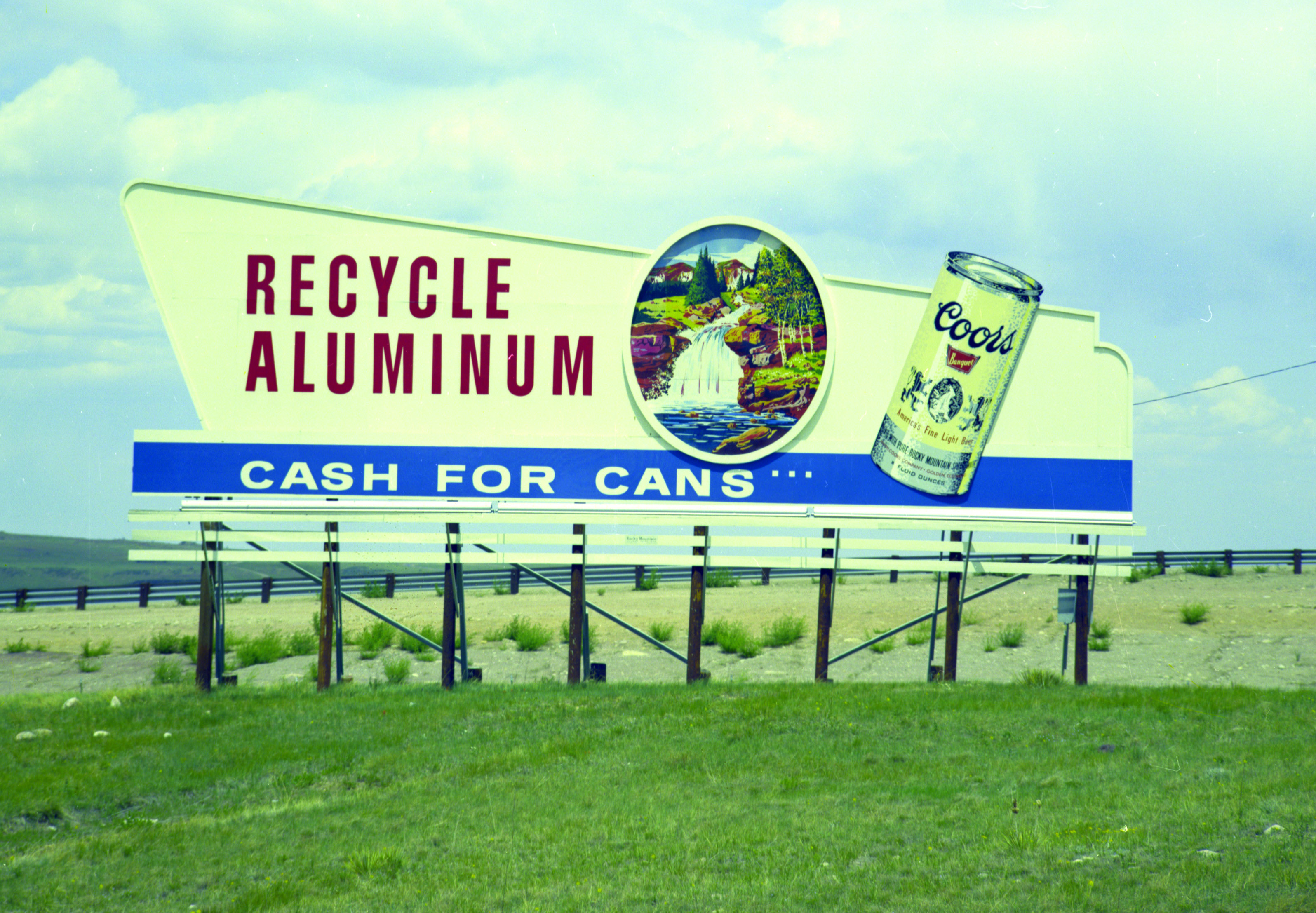 A billboard ad reading: "Recycle Aluminum. Cash for Cans. Coor's."