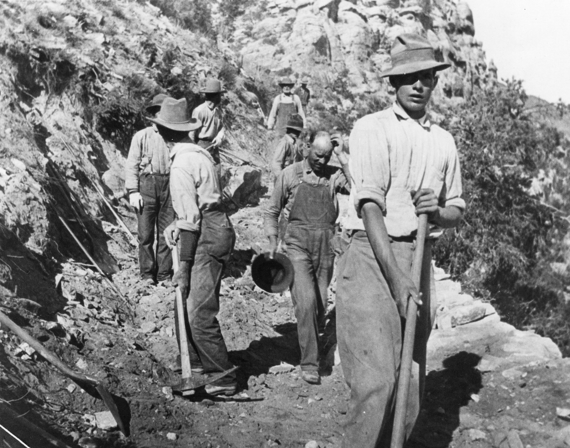 Civilian Conservation Corps (CCC) workers constructing a road in the Colorado mountains, 1930s.